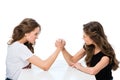 side view of angry twins armwrestling at table Royalty Free Stock Photo