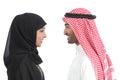 Side view of an arab saudi couple looking each other