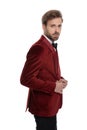 Side view of arrogant young man wearing red velvet tuxedo Royalty Free Stock Photo