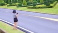 Asian female tourist using digital camera to taking picture of beautiful green topiary garden on roadside in the hill Royalty Free Stock Photo