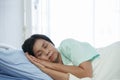 Side view of Asian senior patient woman sleeping at hospital bed with saline bag Royalty Free Stock Photo