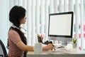 Side view of asian woman looking at computer monitor, working on designer project in creative office Royalty Free Stock Photo