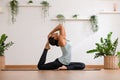 Side view Asian woman wearing green sportwear doing Yoga exercise.Yoga One Legged King Pigeon pose or Eka Pada Rajakapotasana.Calm Royalty Free Stock Photo