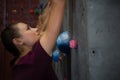 Side view of athlete climbing wall in gym Royalty Free Stock Photo