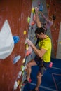 Side view of athletes rock climbing in fitness club Royalty Free Stock Photo