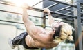 Side view of athletic man exercising calisthenics workout move on horizontal bar outdoors - Modern alternative work out