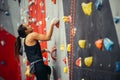 Side view of athletic woman climbing indoors Royalty Free Stock Photo