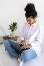 Focused african american teenage girl working on laptop