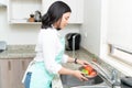 Gorgeous Housewife Cleaning Vegetables In Kitchen Royalty Free Stock Photo