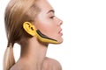 side view of attractive woman with yellow and black paints on ear and face Royalty Free Stock Photo