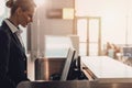 side view of attractive young airport worker at workplace at airport check