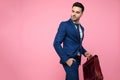 Side view of attractive young man holding suitcase Royalty Free Stock Photo