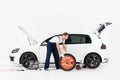 side view of auto mechanic in blue uniform changing car tire