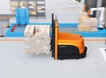 Side view of autonomous forklift carrying pallet of goods in modern logistics center