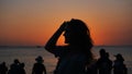 Side view of back light of a woman silhouette warm sunset in front of sun