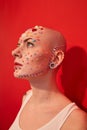 Mannish female with piercing and decor at her face looking away Royalty Free Stock Photo
