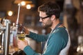 Side view of bartender making drinks while wearing eyeglasses