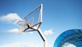 Side view of a basketball hoop with a backboard on a sports field, against a blue sky. Achievement, sports concept Royalty Free Stock Photo