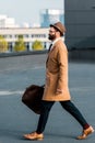 side view of bearded businessman with bag walking Royalty Free Stock Photo