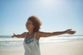 Woman standing with arms outstretched on the beach Royalty Free Stock Photo