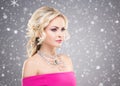 Side view of beautiful blond in pink dress wearing necklace with Royalty Free Stock Photo