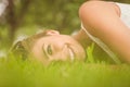 Side view of beautiful happy woman lying on grass Royalty Free Stock Photo