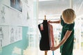 Female fashion designer using measuring tape on a mannequin in studio Royalty Free Stock Photo