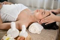 Side view, Beautiful and relaxed Asian woman receiving Thai massage, getting massage on her head Royalty Free Stock Photo