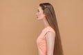 Side view of beautiful serious woman with long brown hair. Royalty Free Stock Photo