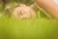 Side view of beautiful smiling woman lying on grass Royalty Free Stock Photo