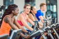 Side view of a beautiful woman smiling while cycling during spinning class Royalty Free Stock Photo