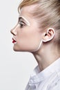 Side view of beautiful young woman. Female with an unusual creative makeup face paintin Royalty Free Stock Photo