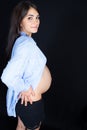 Side view of beauty pretty pregnant woman profile in black background Royalty Free Stock Photo