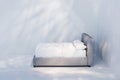 Side view of bed with white linen. Light and shadows on white wall Royalty Free Stock Photo