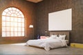 Side view of a bedroom with dark concrete walls. There is an arc shaped window Royalty Free Stock Photo