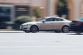 side view of beige Jaguar XF X250. Fast moving car on the street. Vehicle driving along the street in city with blurred background Royalty Free Stock Photo