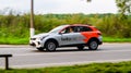 Side view Belka car moving on rural asphalt road. Driver in rental white car riding on the village road on high speed Royalty Free Stock Photo