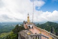 Side view of Big Golden Buddha statue against cloudy sky in Tiger Cave temple