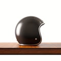 Side view of black color vintage style motorcycle helmet on natural wooden desk.Concept classic object white background