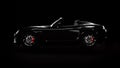 Side view of Black convertible car on dark background 3d illustration