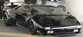 Side view of Black Lamborghini sports car with black wheels