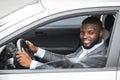 Side view of black man driver looking through car window Royalty Free Stock Photo