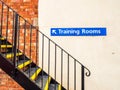 Side view of black metal stair with directional sign Training Rooms Royalty Free Stock Photo