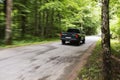 Side view of a black pickup truck in the woods Royalty Free Stock Photo