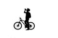 Side view on black silhouette of cyclist is drinking water from bottle on white background. Male bicyclist in bicycle Royalty Free Stock Photo
