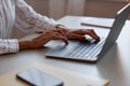 Side view black woman using laptop female hands typing at keyboard Royalty Free Stock Photo