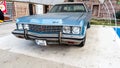 Side view of a blue Cadillac Eldorado under the canopy. careful storage of a vintage car. car show outdoor. restoration