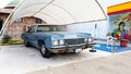 Side view of a blue Cadillac Eldorado under the canopy. careful storage of a vintage car. car show outdoor. restoration