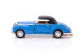 Side view of blue clasic design toy car with black roof