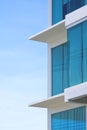 Blue roller blinds inside of glass wall of modern office building against blue sky in vertical frame Royalty Free Stock Photo